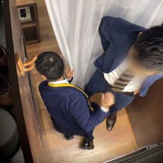 This is a scene of a fitting room involving a Japanese tailor and a horny customer. I wonder if the tailor's cleaning up the mess on the floor before someone steps on it.